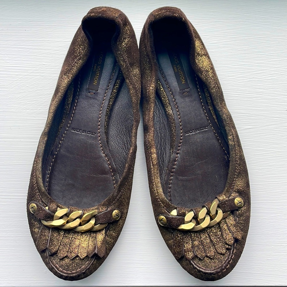 Louis Vuitton metallic gold/black leather ballet flats with chain and tassel.